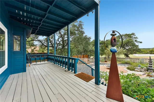 a view of a balcony with wooden floor and outdoor space