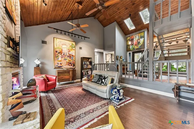 a living room with furniture fireplace and a large window