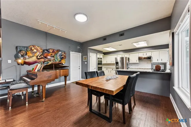 a view of a dining room with furniture and wooden floor