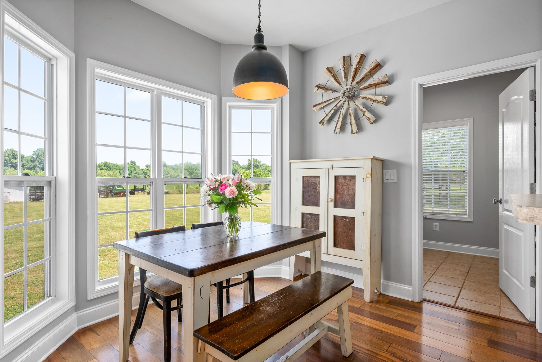 4555 Pineywoods Road Adams, TN 37010 - Photo 12 of 55 a view of a dining room with furniture window and wooden floor
