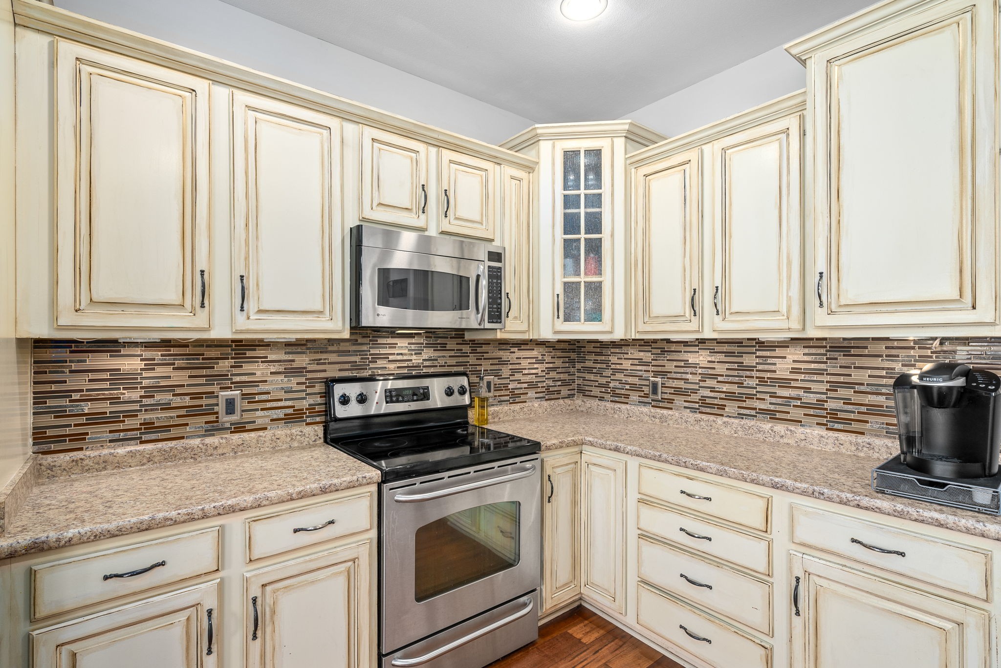 4555 Pineywoods Road Adams, TN 37010 - Photo 15 of 55 a kitchen with granite countertop white cabinets stainless steel appliances a sink and a window