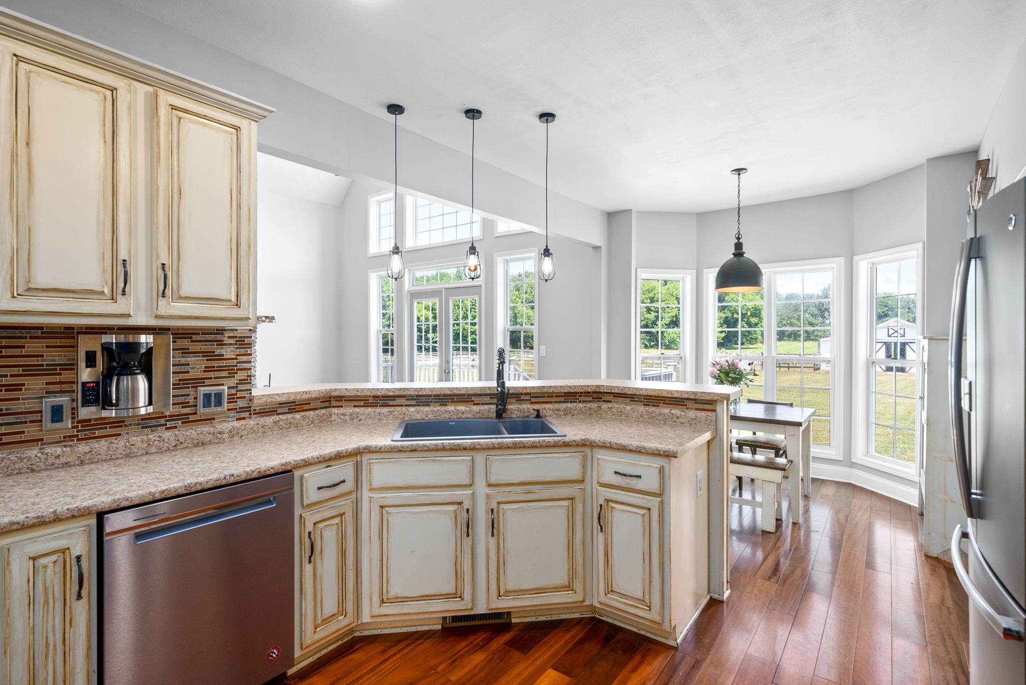 4555 Pineywoods Road Adams, TN 37010 - Photo 16 of 55 a kitchen with kitchen island granite countertop a stove a sink a center island and wooden floor