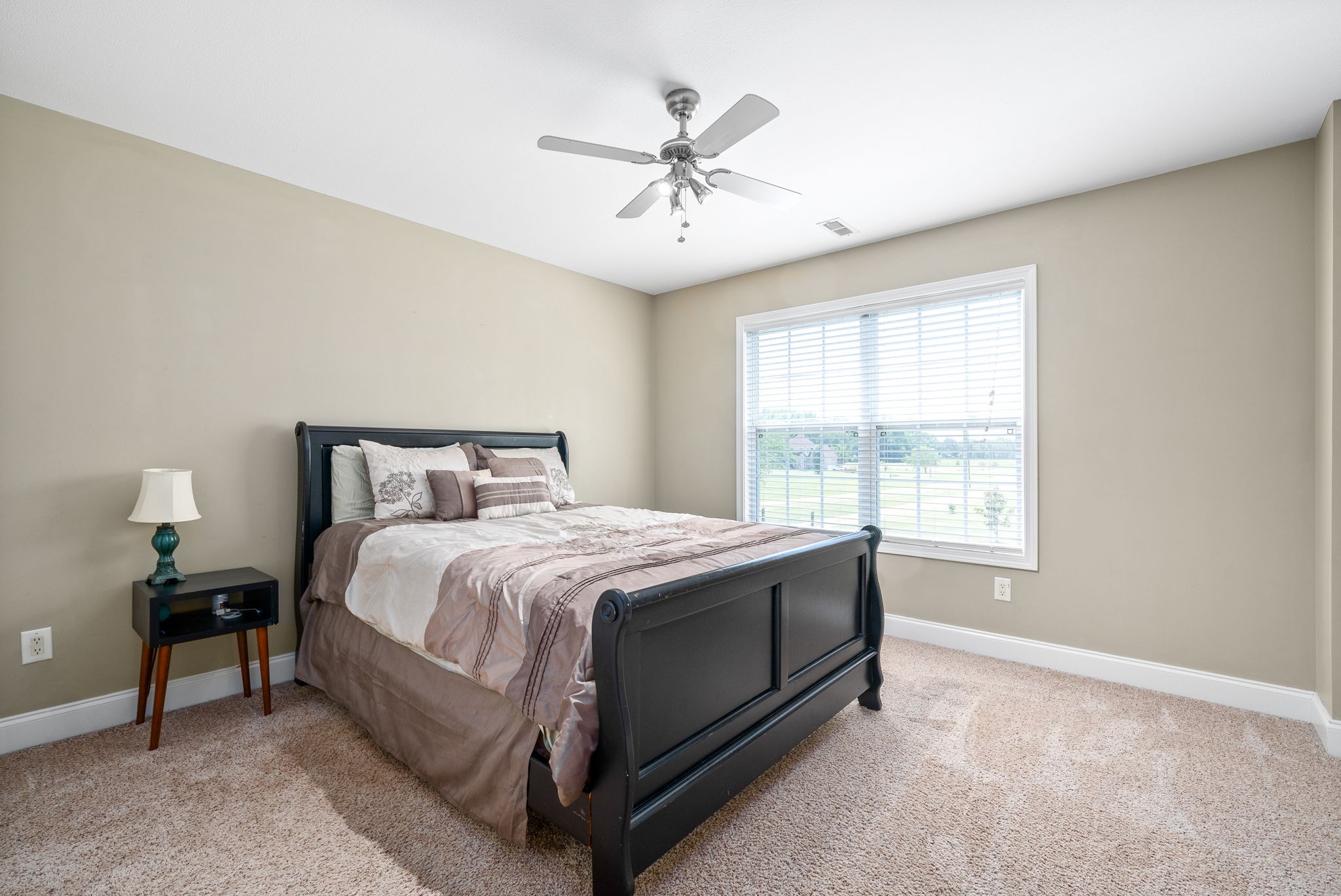 4555 Pineywoods Road Adams, TN 37010 - Photo 29 of 55 a bed sitting in a bedroom next to a window