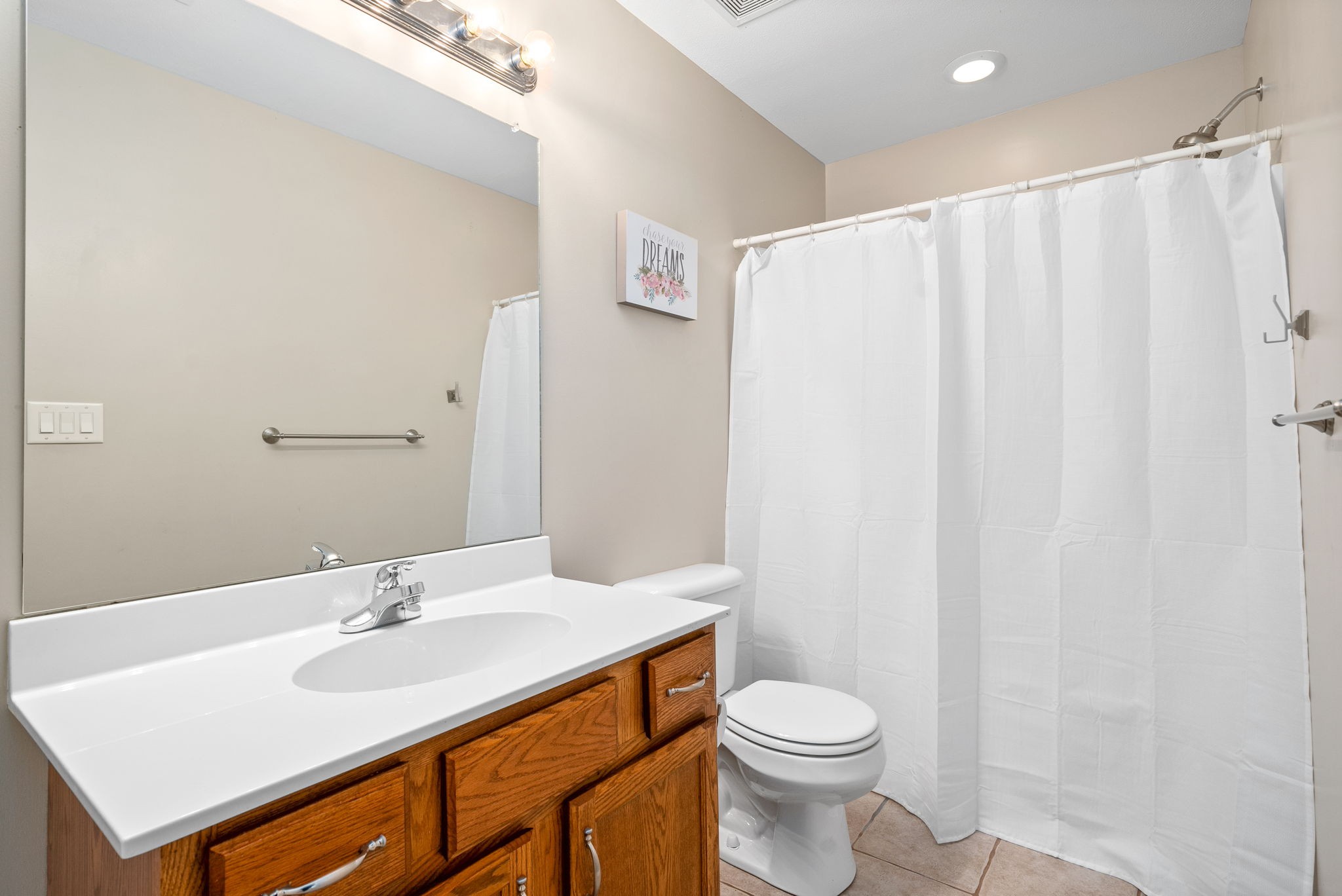 4555 Pineywoods Road Adams, TN 37010 - Photo 30 of 55 a bathroom with a sink a toilet and shower curtain