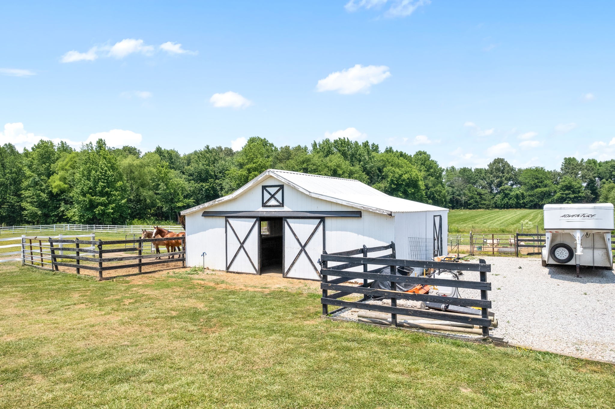 4555 Pineywoods Road Adams, TN 37010 - Photo 42 of 55 a view of a patio with table and chairs a barbeque with wooden fence