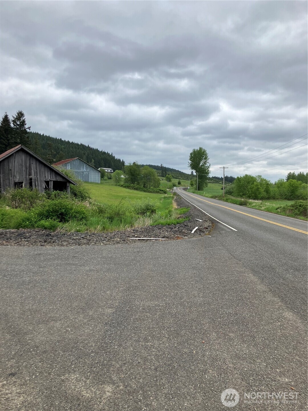 112 South Blacksmith Road Rochester, WA 98579 - Photo 5 of 5 a view of a road with a big yard