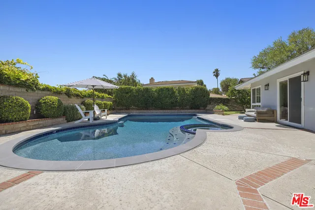 a view of a swimming pool with a patio