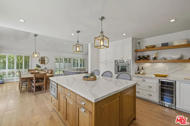 an open kitchen with sink and cabinets