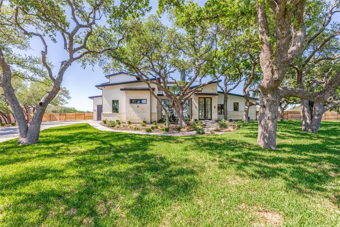a front view of a house with yard and green space