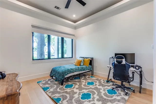 a bedroom with a bed a couch and a large window