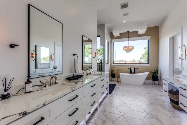 a spacious bathroom with a double vanity sink a mirror and a shower