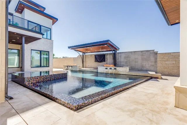 a front view of a house with a yard and tree s