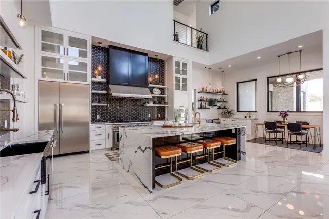 a kitchen with stainless steel appliances a stove and cabinets