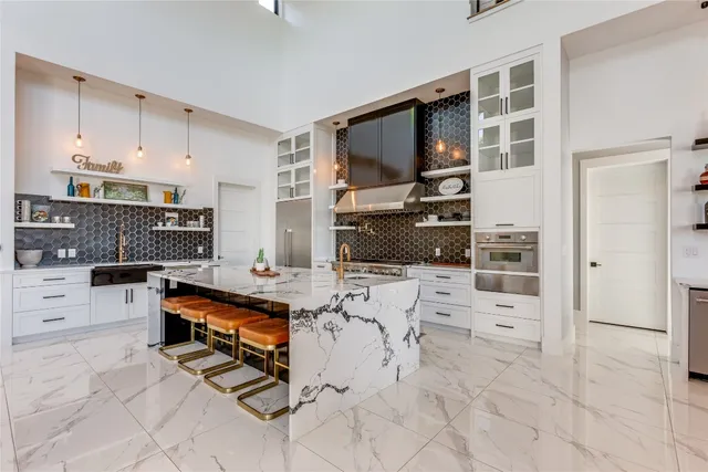 a kitchen with stainless steel appliances a sink stove and cabinets
