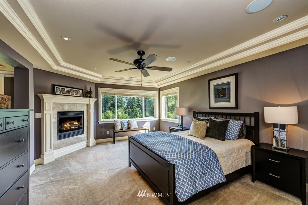 5370 Northeast 17th Street Renton, WA 98059 - Photo 12 of 25 a spacious bedroom with a large bed and a fireplace