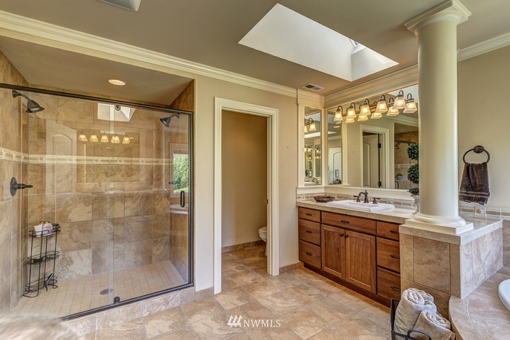 5370 Northeast 17th Street Renton, WA 98059 - Photo 15 of 25 a spacious bathroom with a glass shower door and a sink