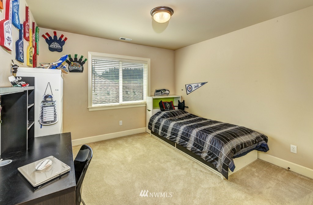 5370 Northeast 17th Street Renton, WA 98059 - Photo 17 of 25 a bedroom with a bed and a window