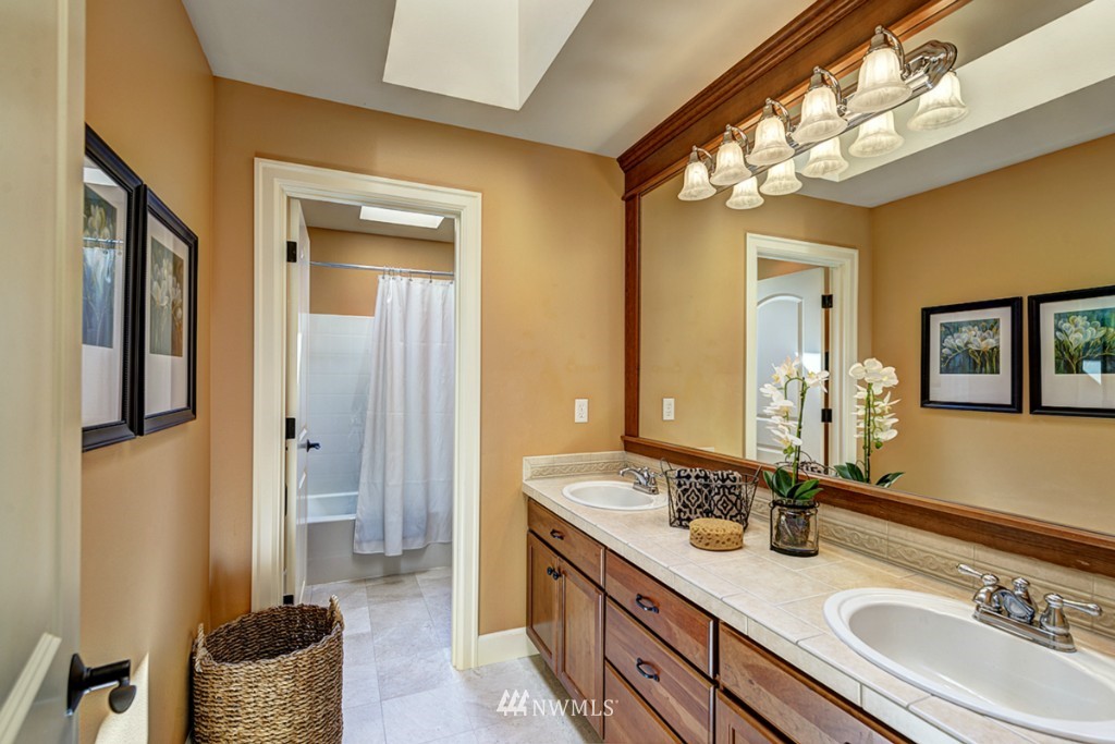 5370 Northeast 17th Street Renton, WA 98059 - Photo 19 of 25 a bathroom with a granite countertop sink and a mirror