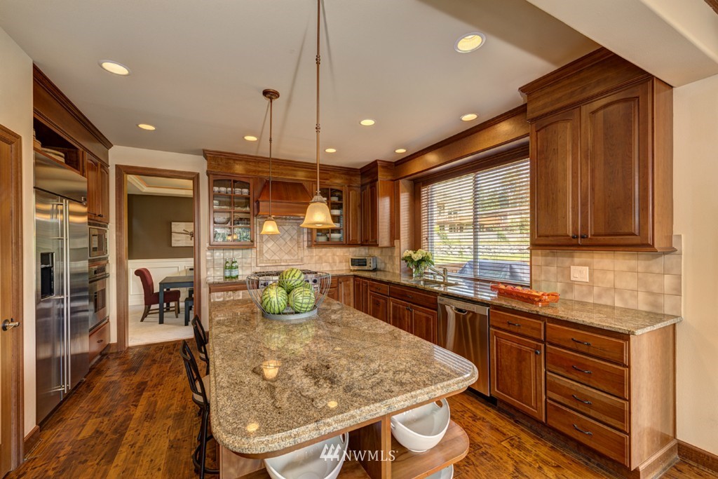 5370 Northeast 17th Street Renton, WA 98059 - Photo 5 of 25 a kitchen with stainless steel appliances granite countertop a sink a stove and a refrigerator