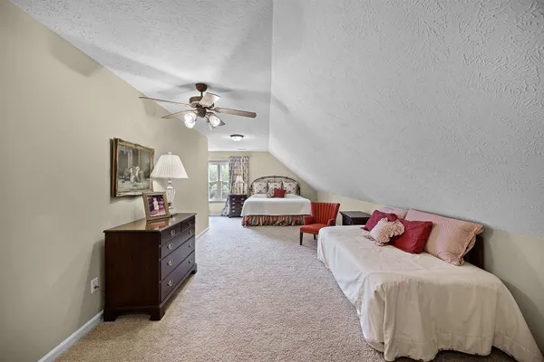 a bedroom with bed and window
