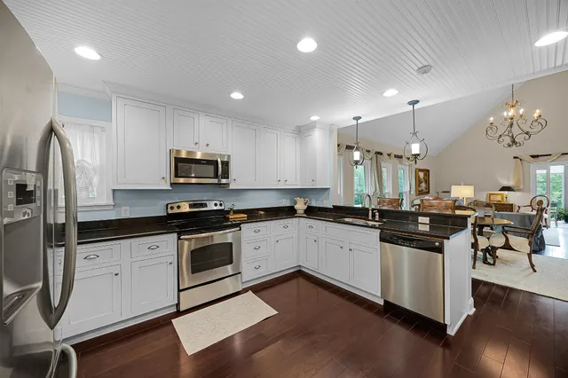 a kitchen with granite countertop stainless steel appliances and wooden cabinets