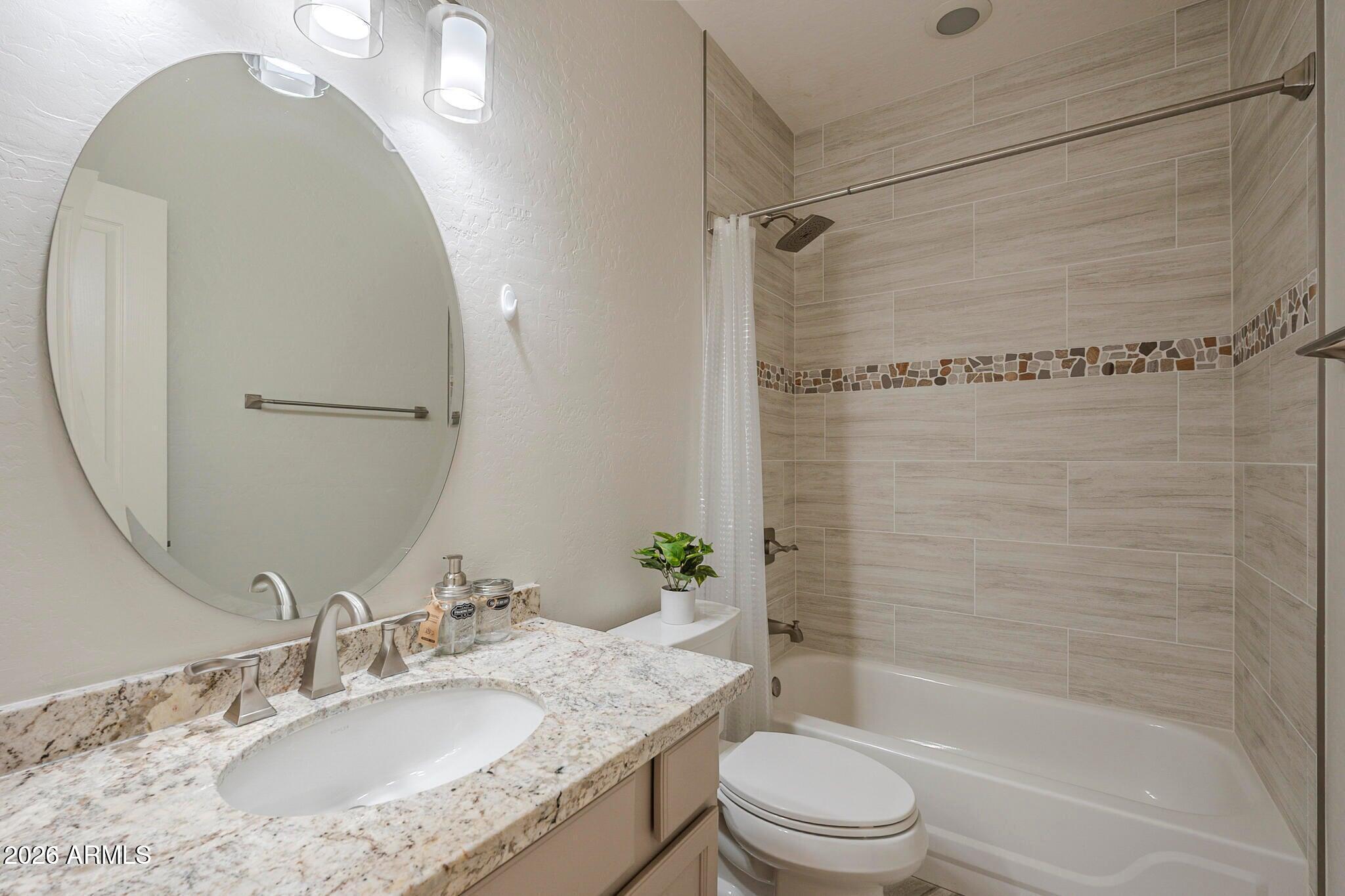 3910 East Carson Road Phoenix, AZ 85042 - Photo 11 of 19 a bathroom with a granite countertop sink toilet and shower