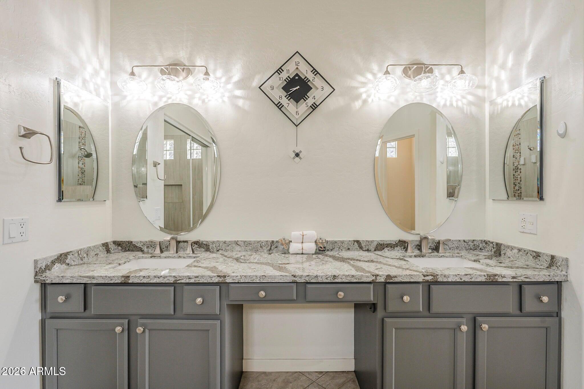 3910 East Carson Road Phoenix, AZ 85042 - Photo 14 of 19 a bathroom with a granite countertop sink and a mirror