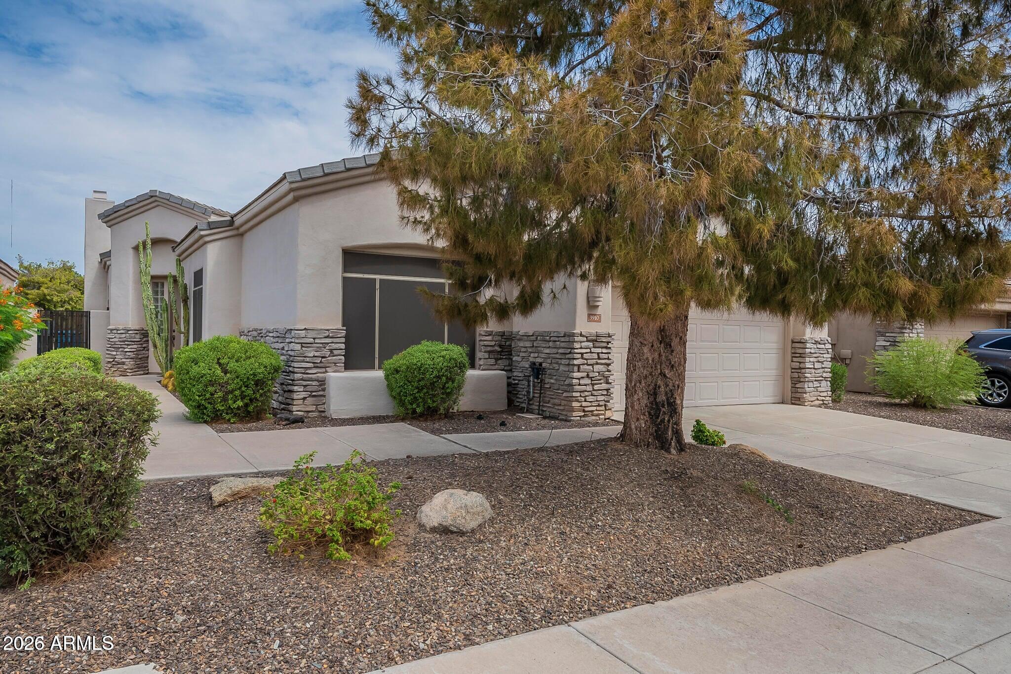 3910 East Carson Road Phoenix, AZ 85042 - Photo 2 of 19 a front view of a house with garden