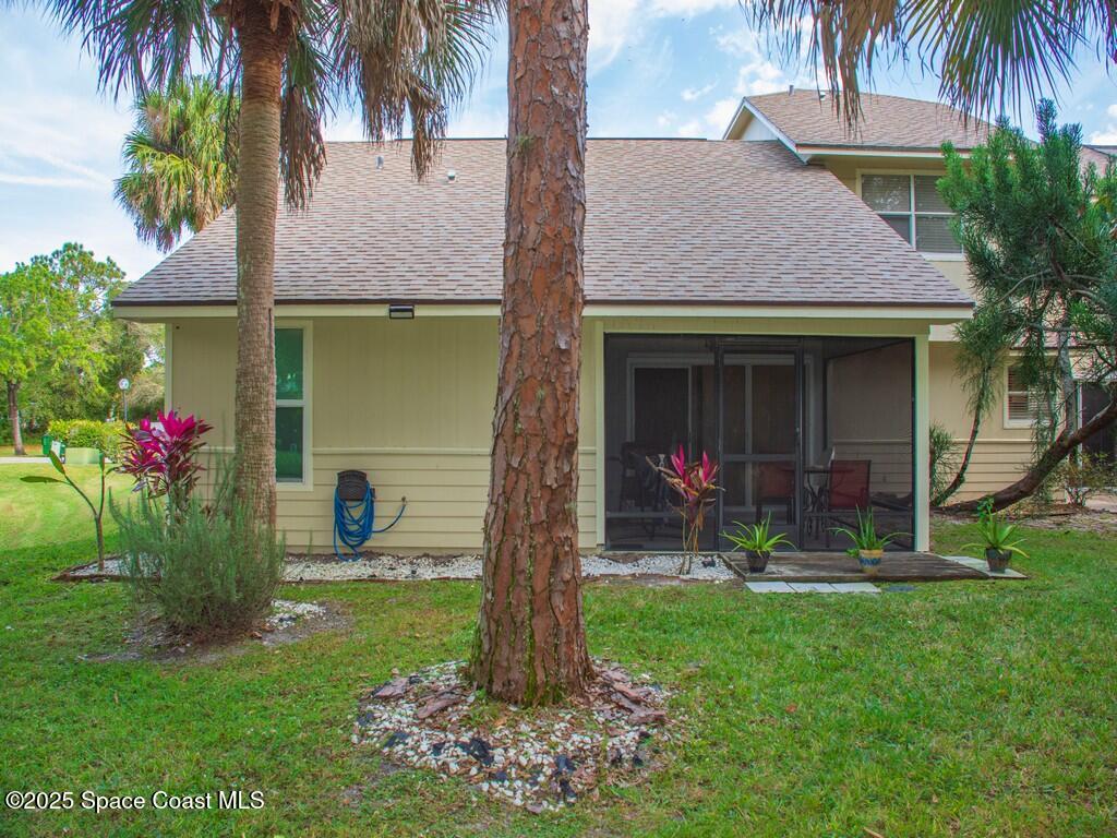 2020 Vero S Circle Southwest, Unit 4 Vero Beach, FL 32962 - Photo 24 of 33 a front view of a house with a garden and plants