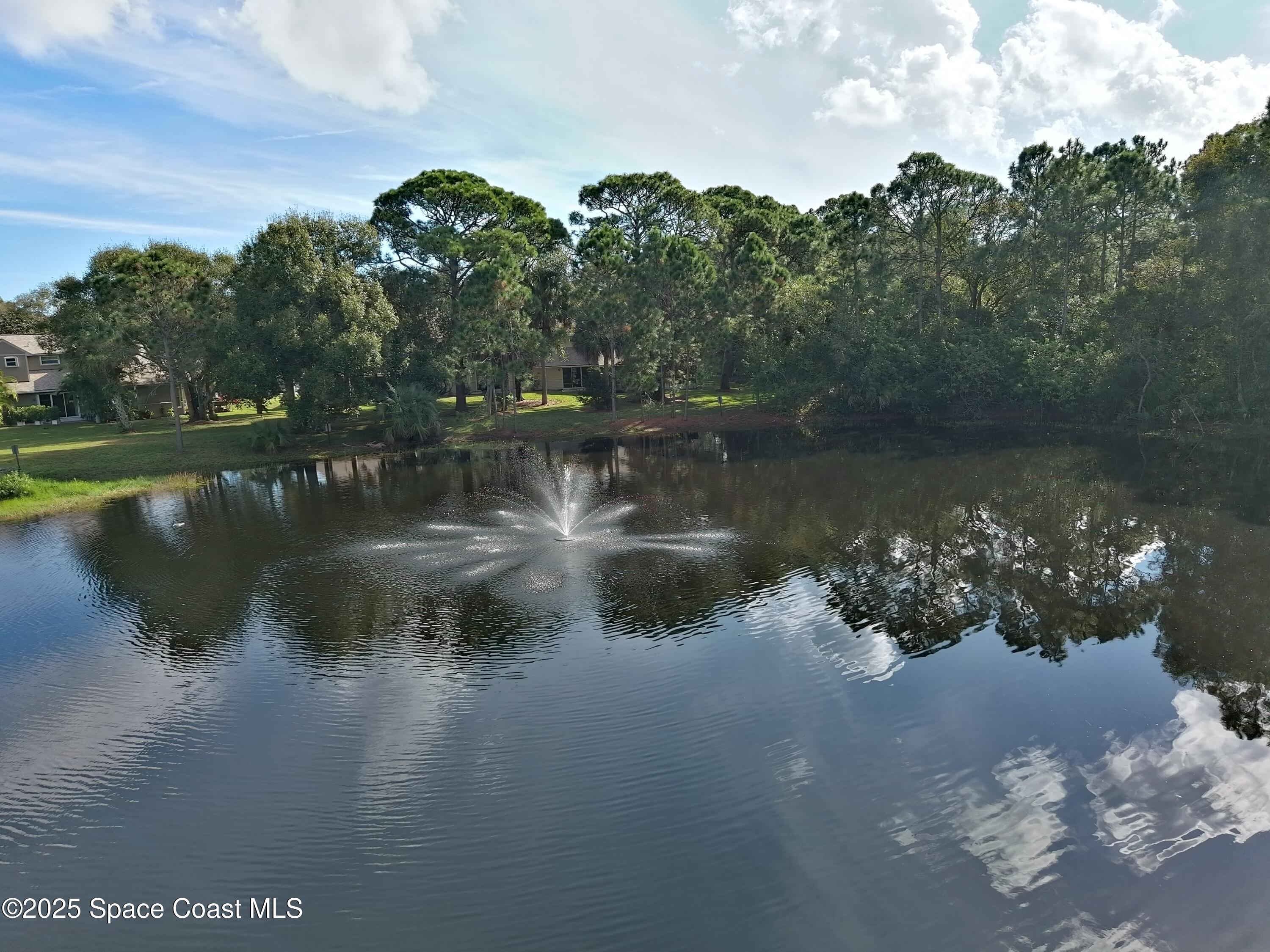 2020 Vero S Circle Southwest, Unit 4 Vero Beach, FL 32962 - Photo 27 of 33 a view of a lake with a mountain in the background