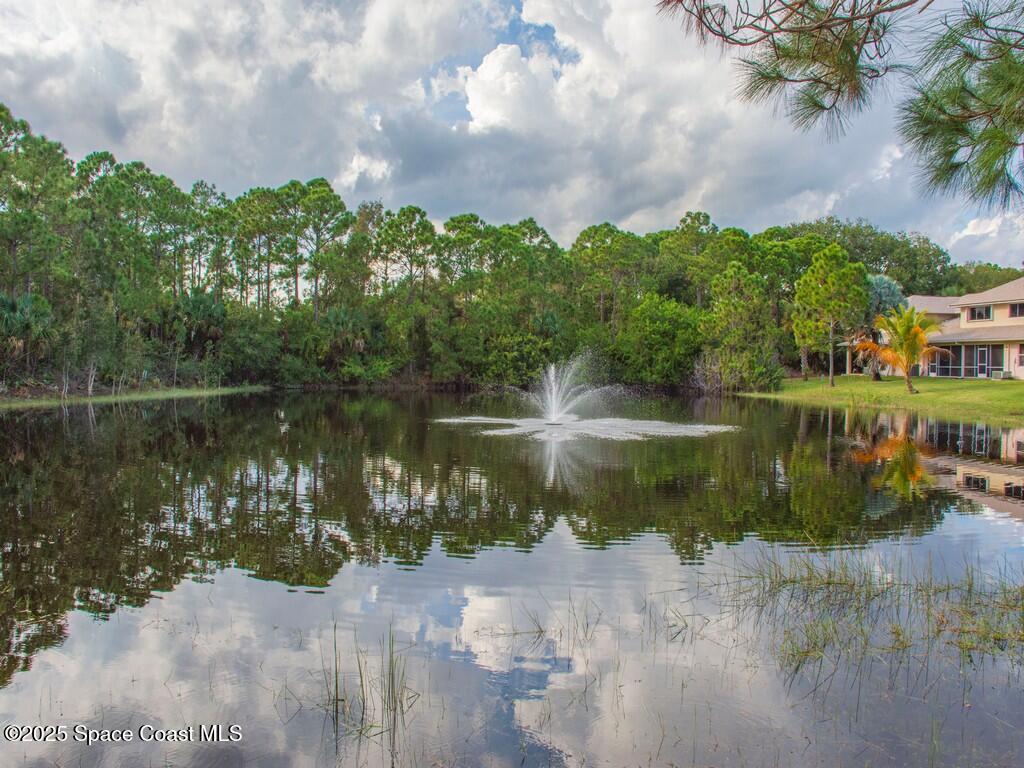 2020 Vero S Circle Southwest, Unit 4 Vero Beach, FL 32962 - Photo 32 of 33 a view of a lake with houses in the back