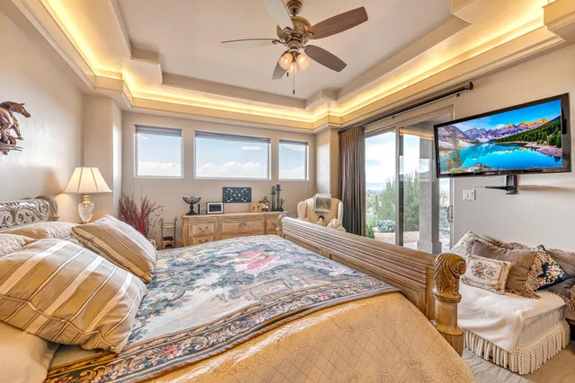 a large bedroom with a bed and glass windows