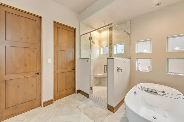 a bathroom with a tub sink and shower