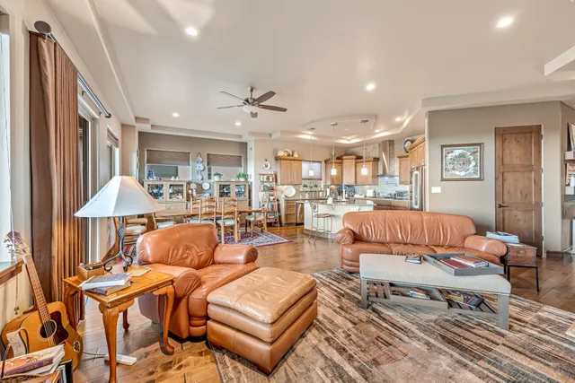 a living room with furniture a rug and a chandelier