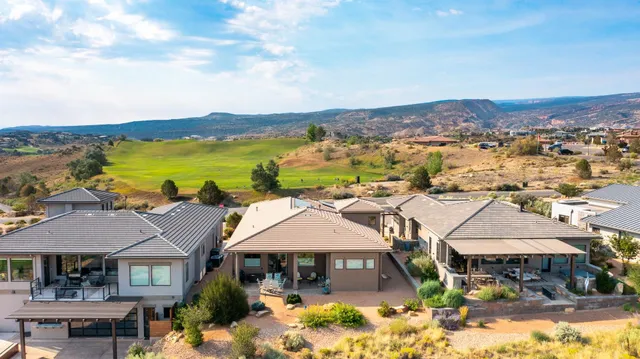 an aerial view of a residential apartment building with a swimming pool and garden