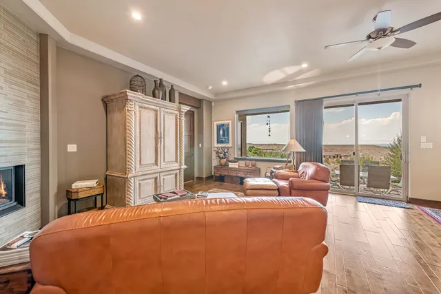 a living room with furniture and a floor to ceiling window