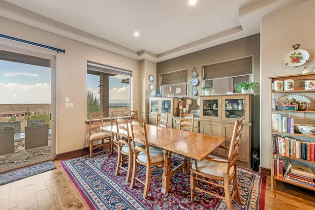 a dining room with furniture wooden floor and a rug