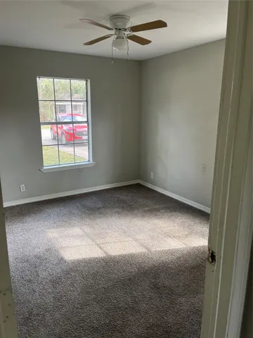 an empty room with a empty space and windows