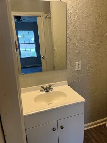 a bathroom with a sink a toilet and window