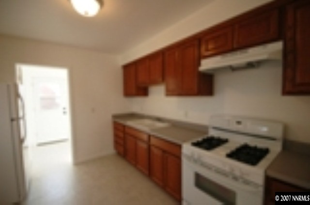 1349 Locust Street Reno, NV 89502 - Photo 5 of 9 a kitchen with a sink and a stove top oven