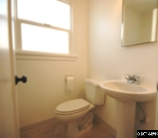 1349 Locust Street Reno, NV 89502 - Photo 8 of 9 a bathroom with a sink a toilet and mirror
