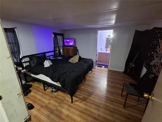 a living room with furniture rug and wooden floor