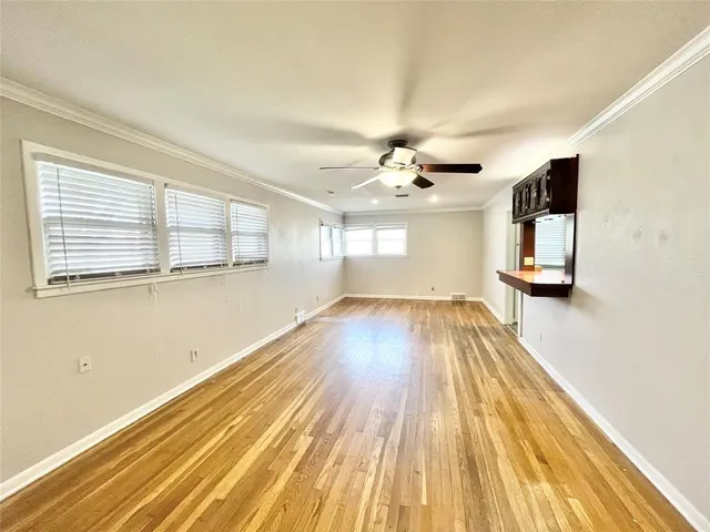 a view of a room with wooden floor and chandelier