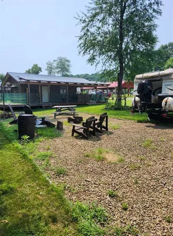 a view of a chair and table in front of a house