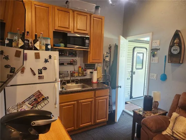 a kitchen with stainless steel appliances a stove a refrigerator and cabinets