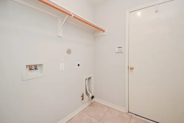 a view of a room with wooden floor chandelier and windows