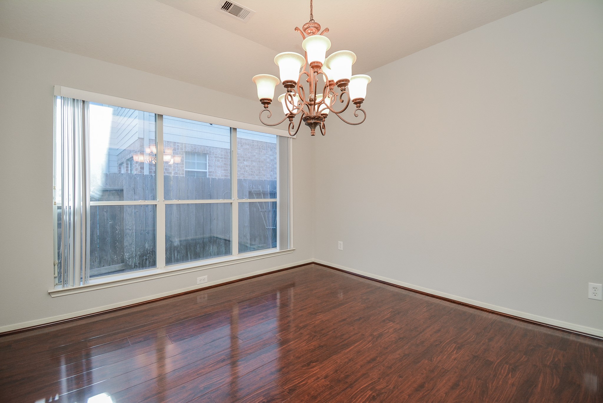 18714 Flagstone Creek Road Houston, TX 77084 - Photo 19 of 50 a view of a room with wooden floor and chandelier