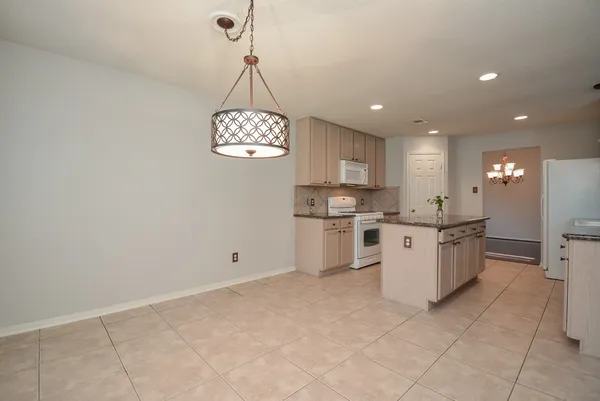 a kitchen with granite countertop a sink and cabinets