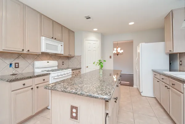 a bathroom with a granite countertop sink a mirror and shower