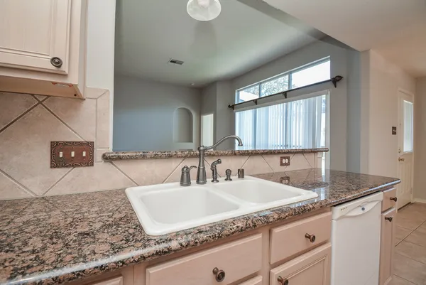 a stove top oven sitting inside of a kitchen